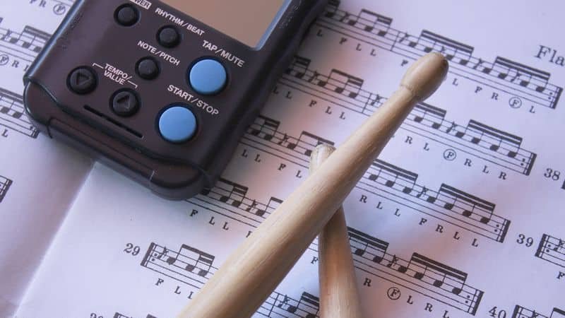 Metronome, drumsticks and notes